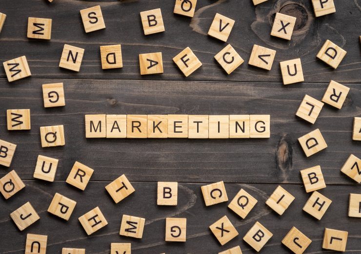 Marketing word wood block on table for business concept.